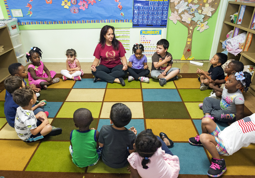 Teacher and young students in classroom