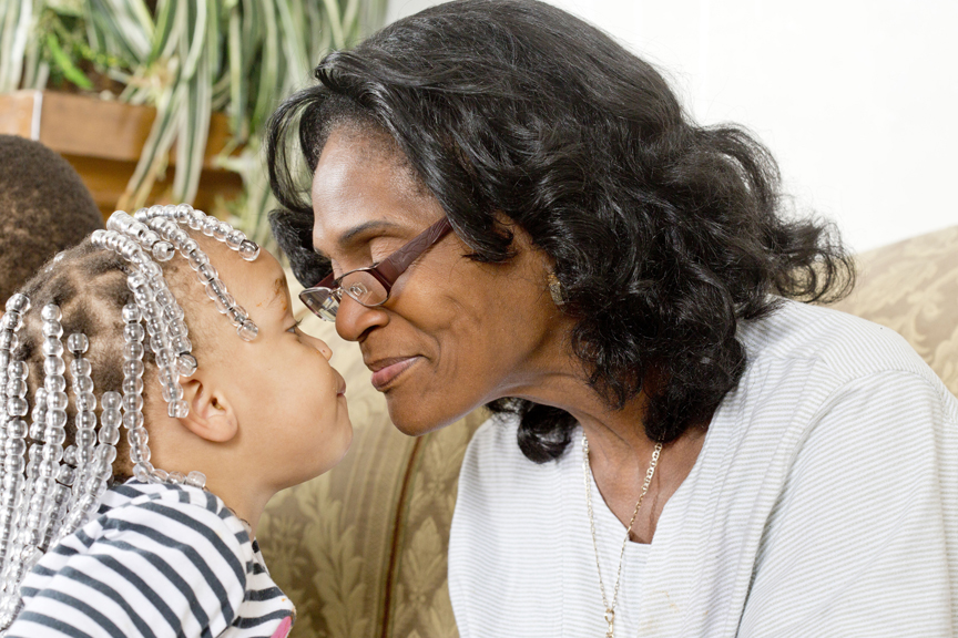 Grandmother kissing granddaughter