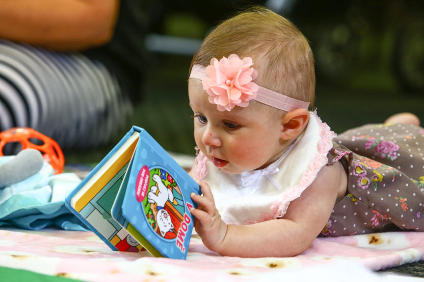 Baby playing with book