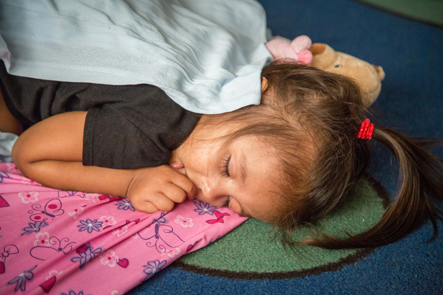 Girl napping and sucking her thumb