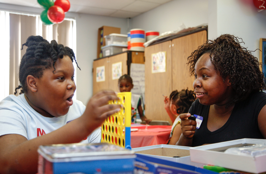 Two girls playing Connect Four game