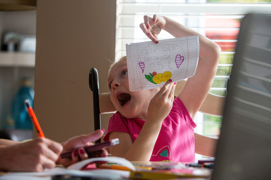 Young girl acting silly showing drawing