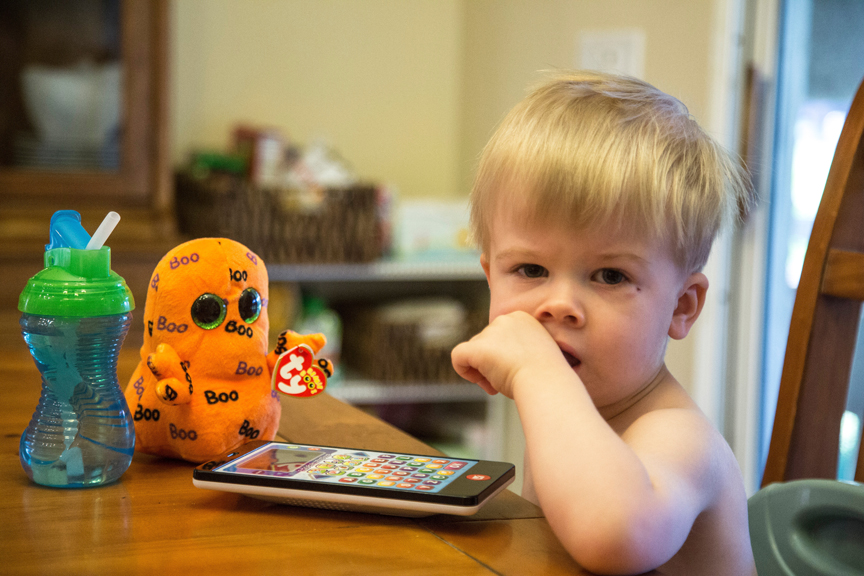 Young child playing on tablet