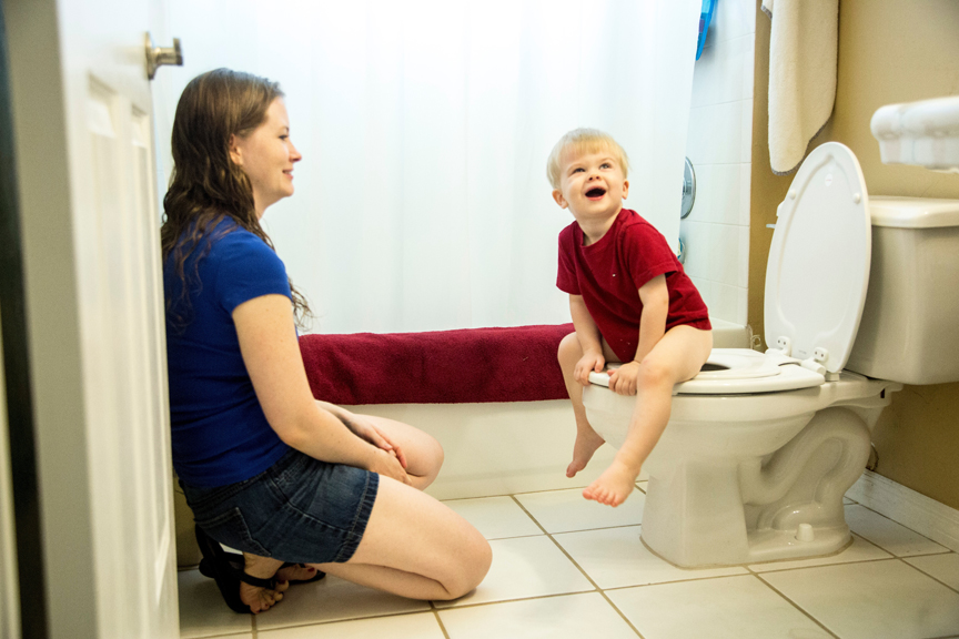 Mother and young son potty training