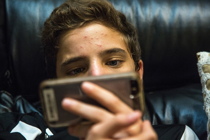 Teenage boy looking at smartphone