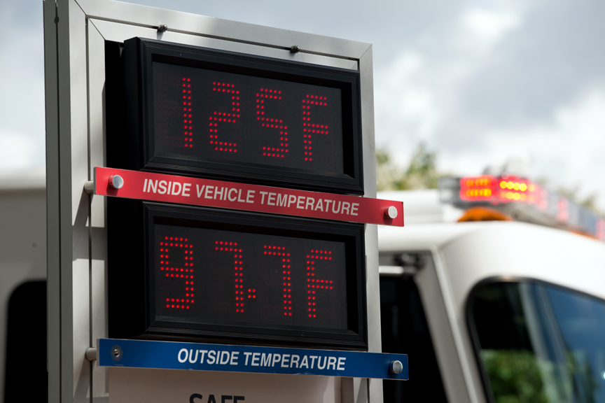 Thermometer showing hot temperature inside vehicle