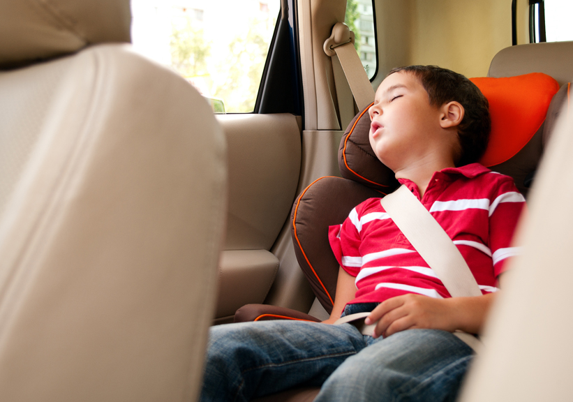Young boy sleeping in carseat