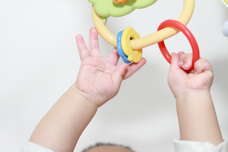 Baby playing with toy rings
