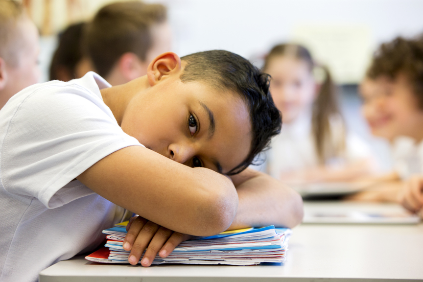 iStock-482423852 Boy with head on stack of books