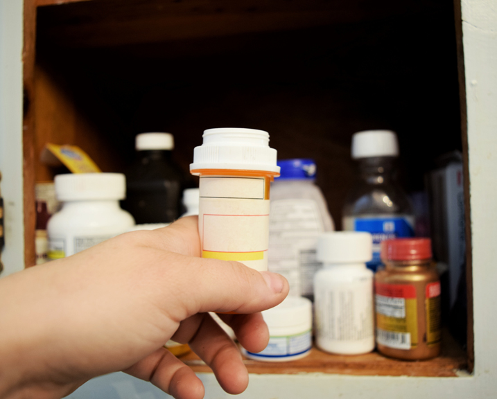 Child reaching in medicine cabinet