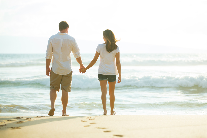 Couple holding hands on beach