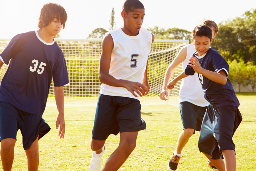 Teenage boys playing soccer