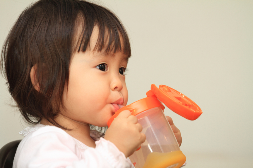 Young girl drinking from cup