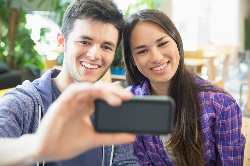 Teen boy and girl taking a selfie