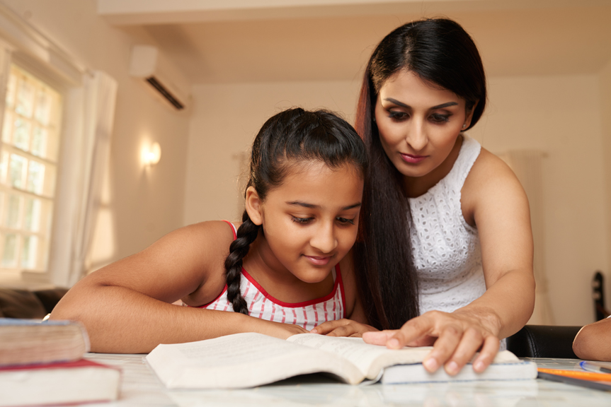 Woman and child reading book