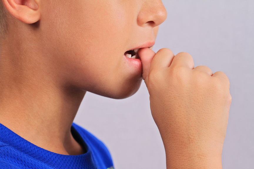 Boy biting thumb
