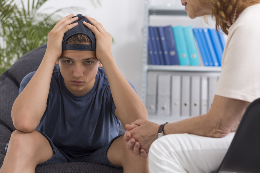 Teen with counselor looking stressed