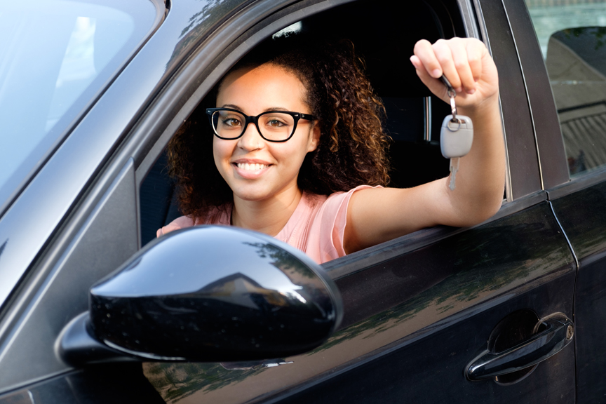 Woman holding keys to car