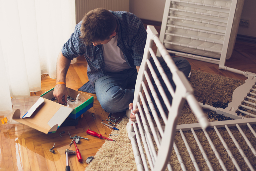 Man assembling crib