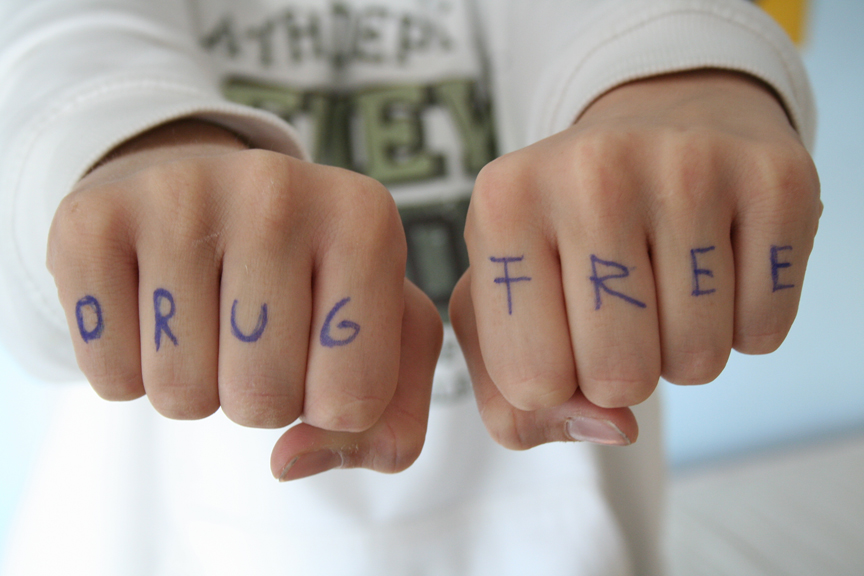 Drug free message written on knuckles