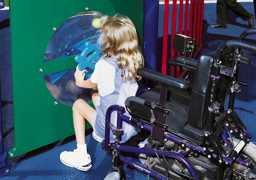 Girl in wheelchair playing on a playground