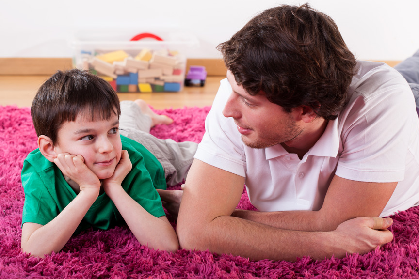 dadsontalking Dad and son talking on floor.