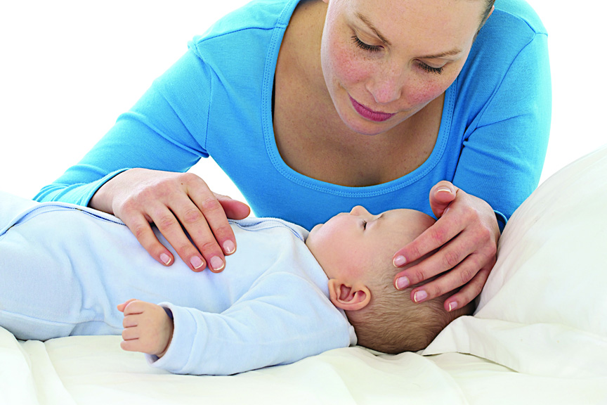 Mom looking down at baby on changing table