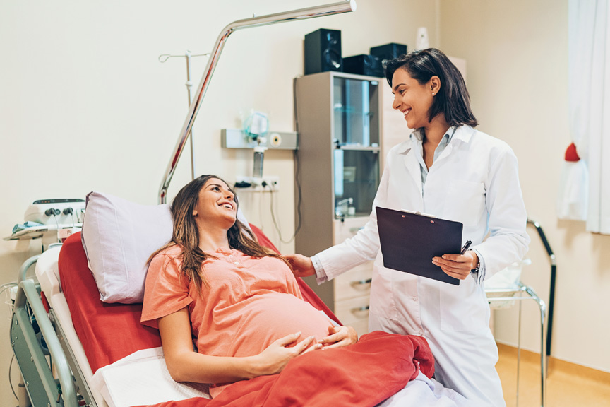 Pregnant woman talking to doctor