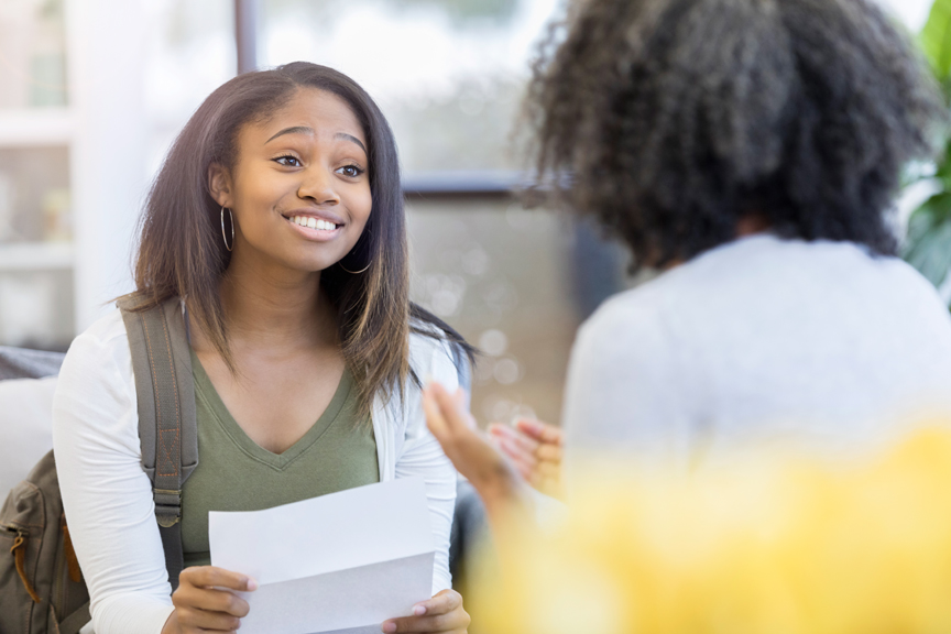 Teen sharing exciting news with adult
