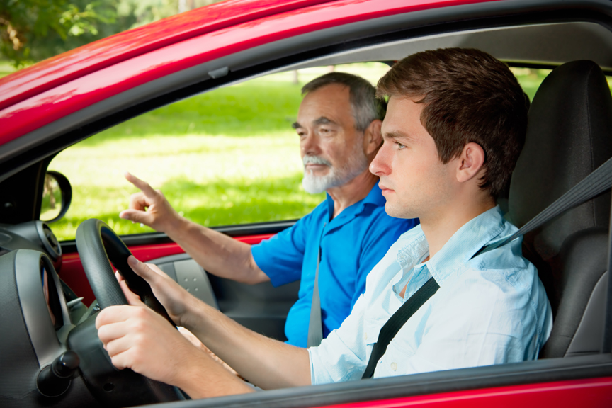 Teenager driving with instructor