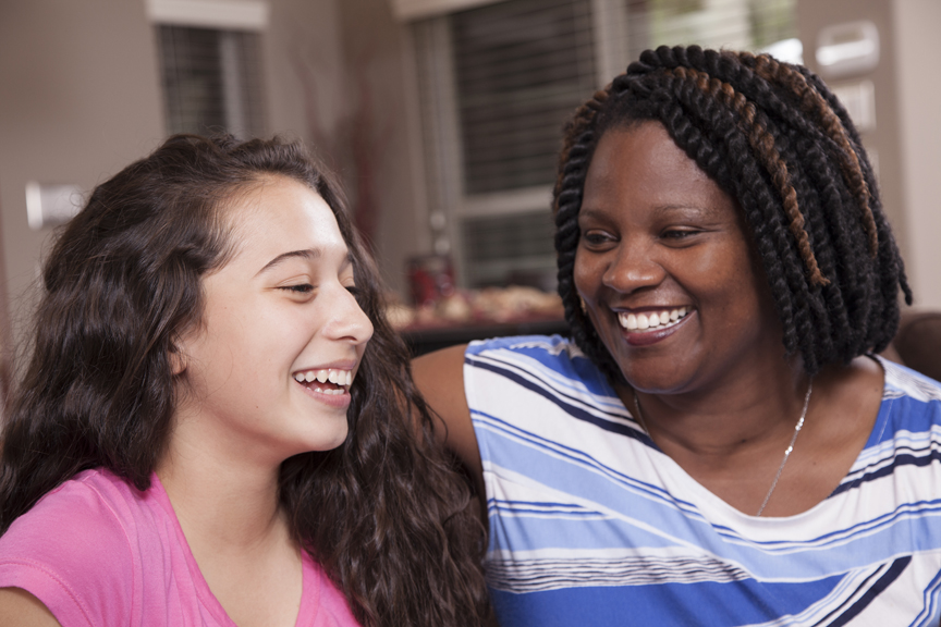 Woman and teenage girl laughing