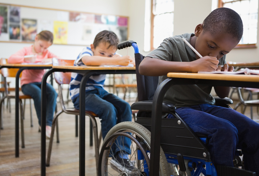Children in classroom writing.