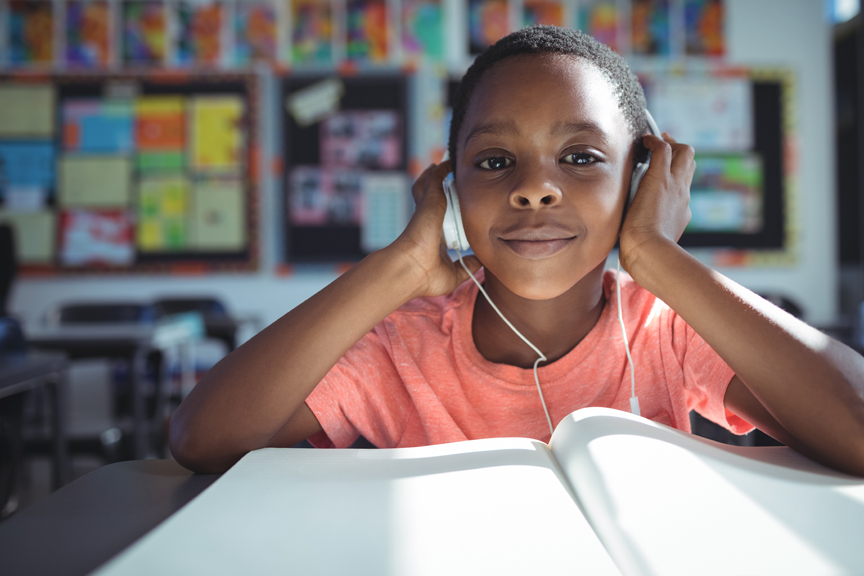 Boy listening through headphones