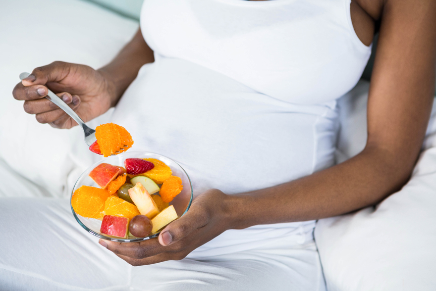 Woman eating fruit salad