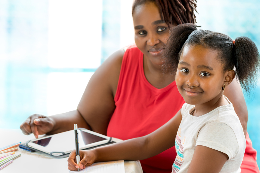 Woman and child writing and smiling