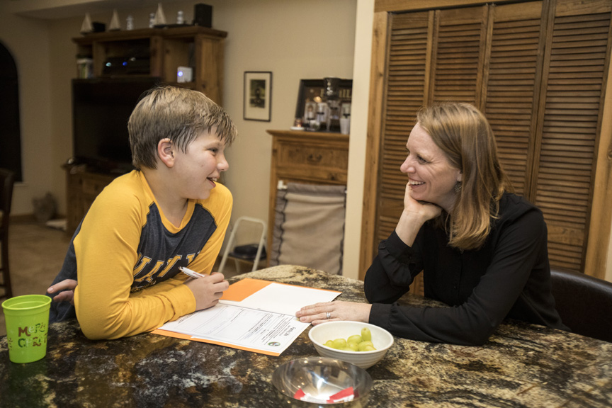 Mother homeschooling son.