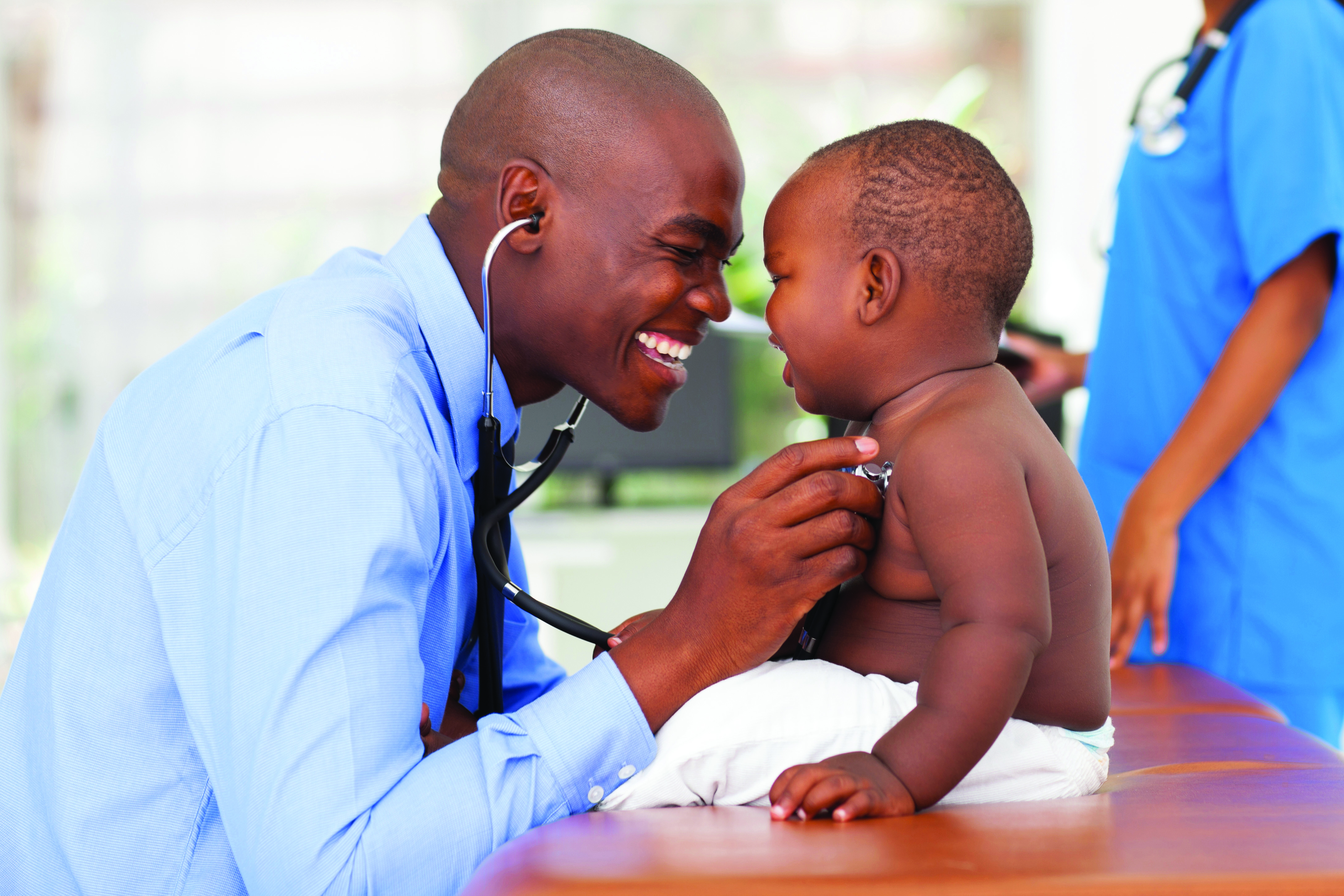 Doctor laughing with baby
