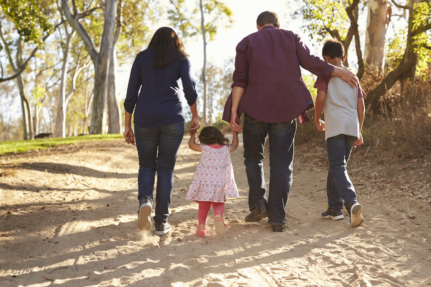 Family walking on sand.