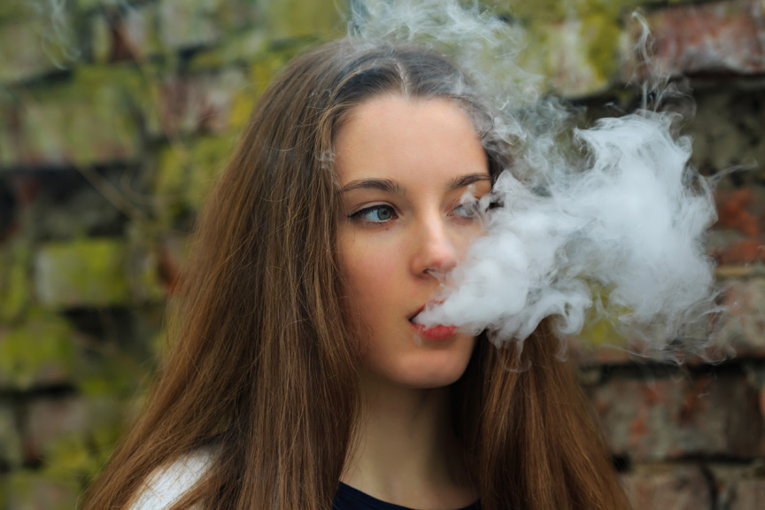 Teenage girl vaping.