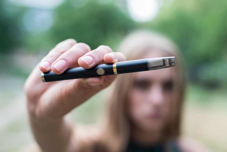 Teenager girl vaping.